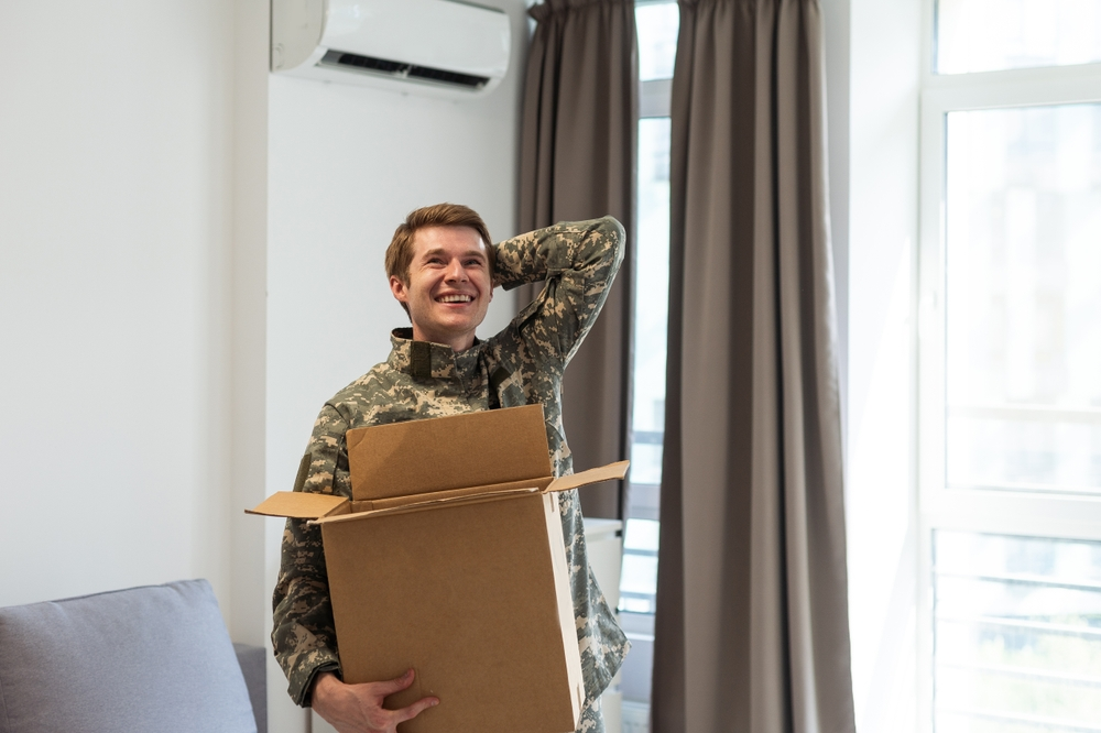 A man in a military uniform smiles joyfully